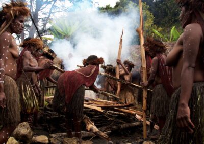 Women around fire during pig festival